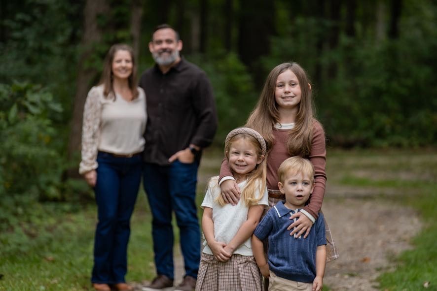 The Greens, a family of five posed together outdoors