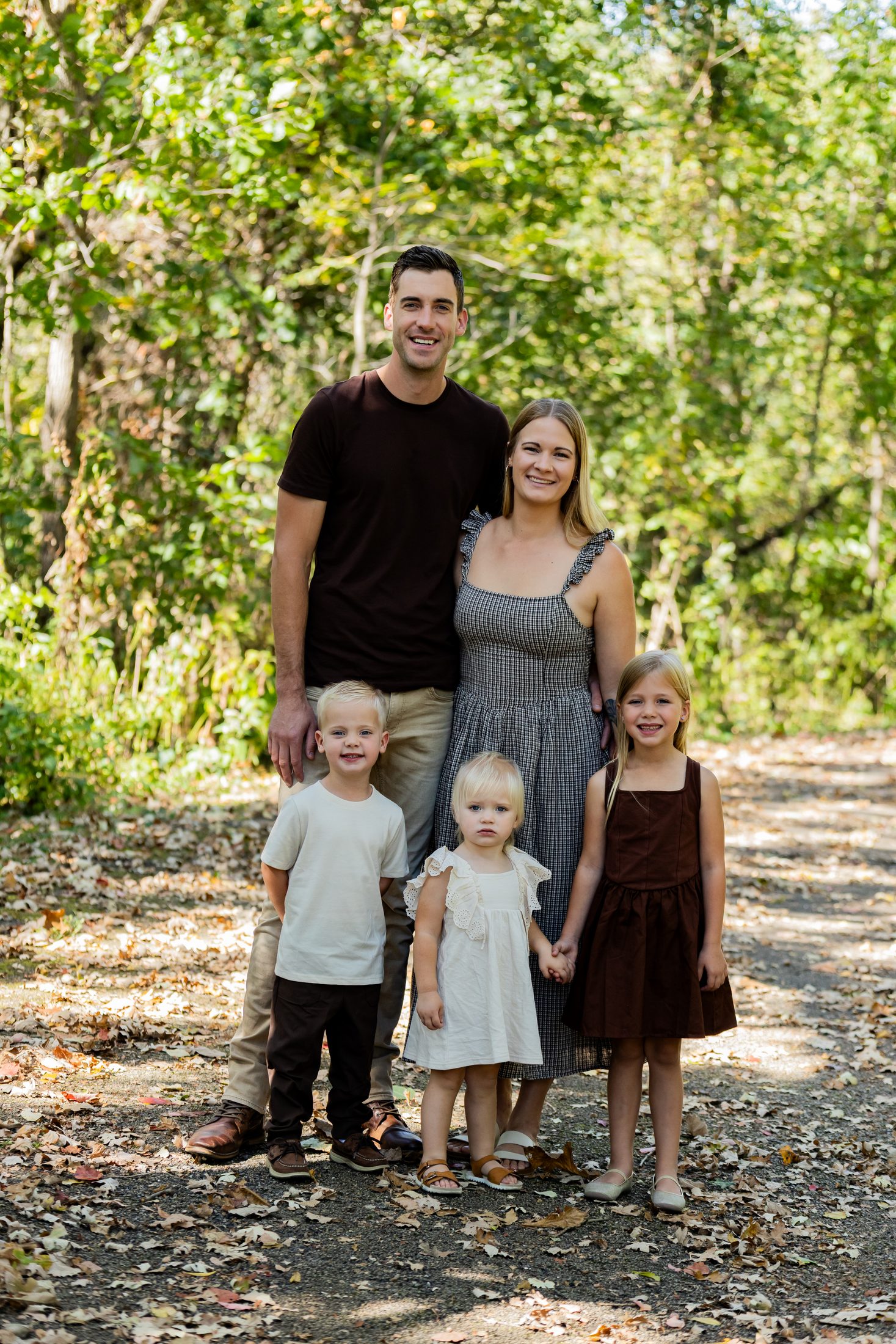 The Duehnings, a family of five standing on a wooded path