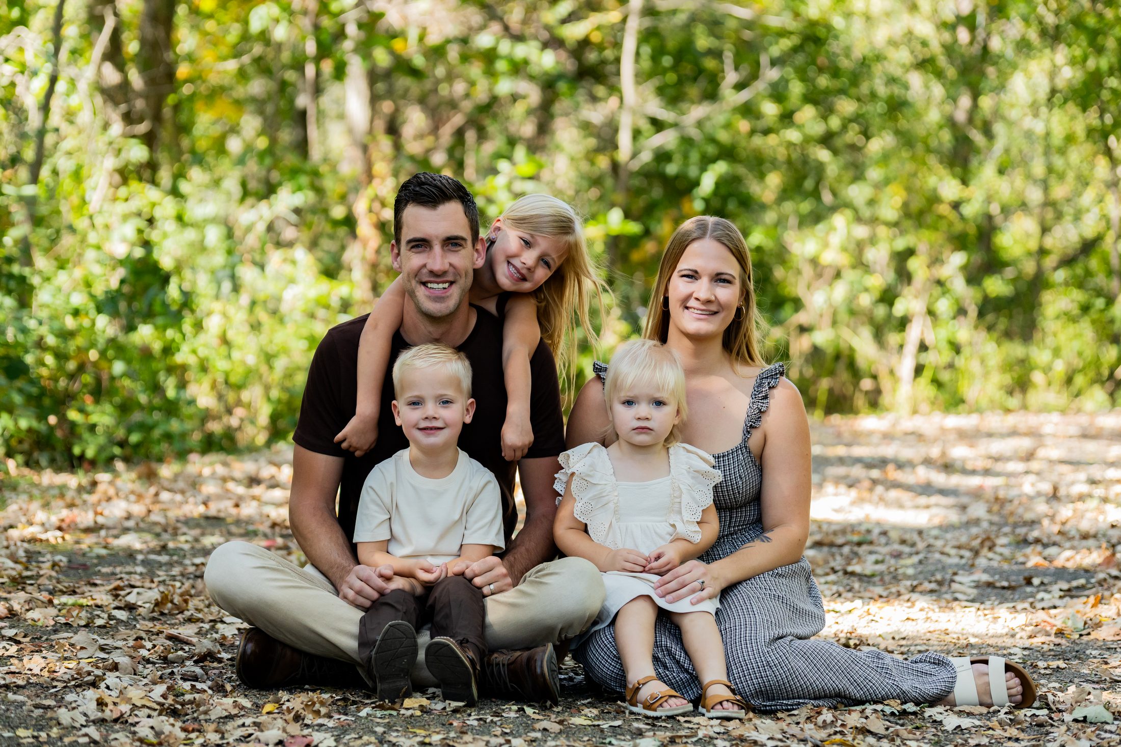 The Duehnings, a family of five sitting together on the ground