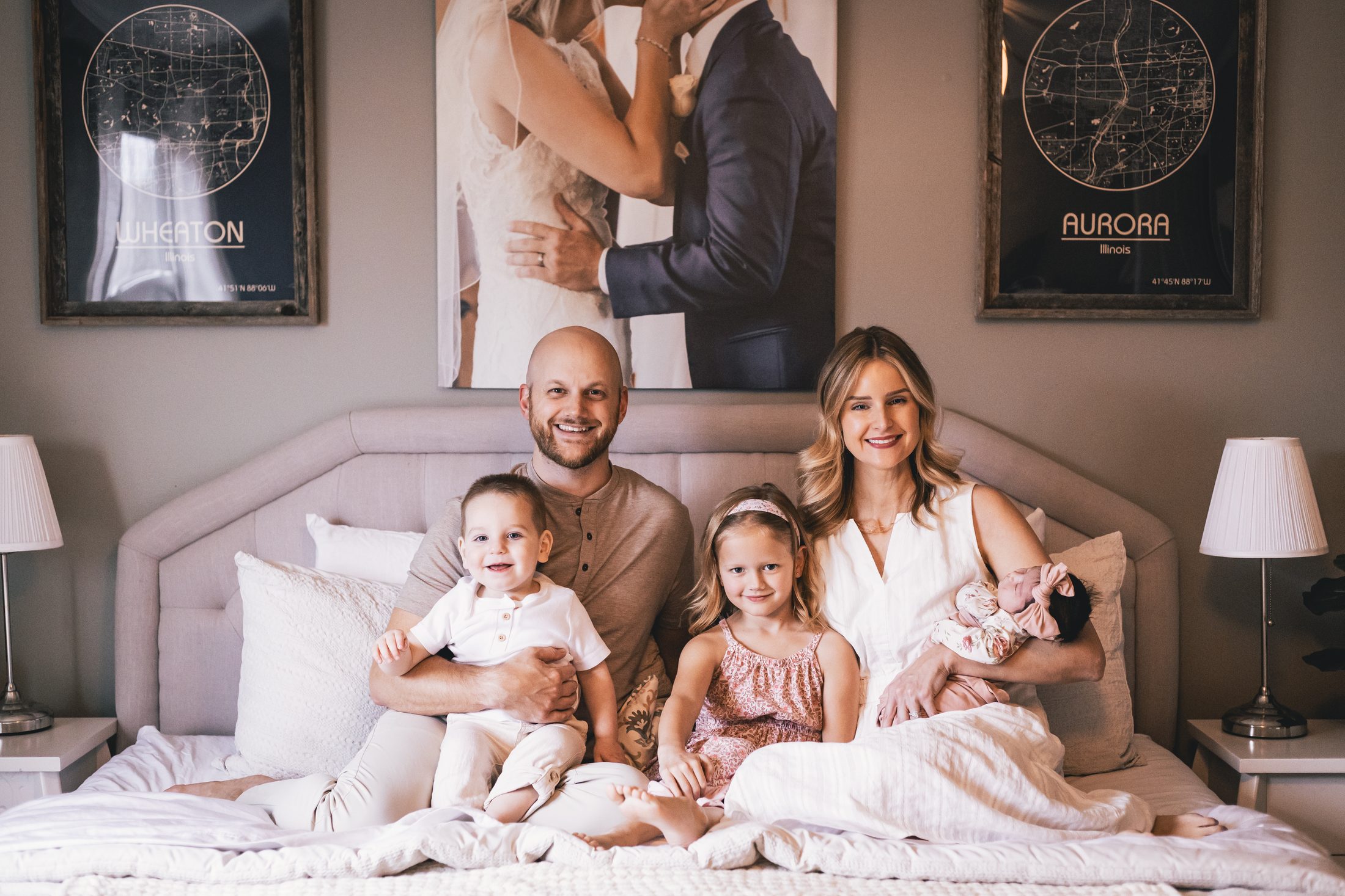 The Simeks, a family of five gathered together on a bed