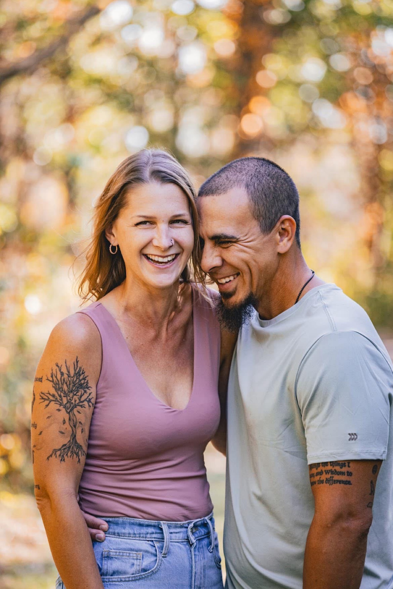 A couple laughing together outdoors in warm fall light