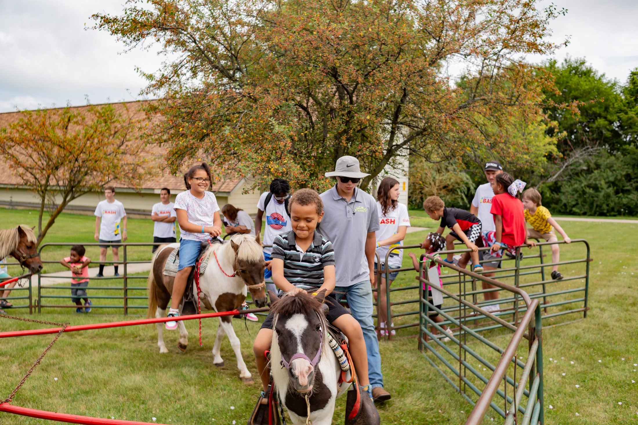 Back to School Bash, children riding ponies in a grassy pen