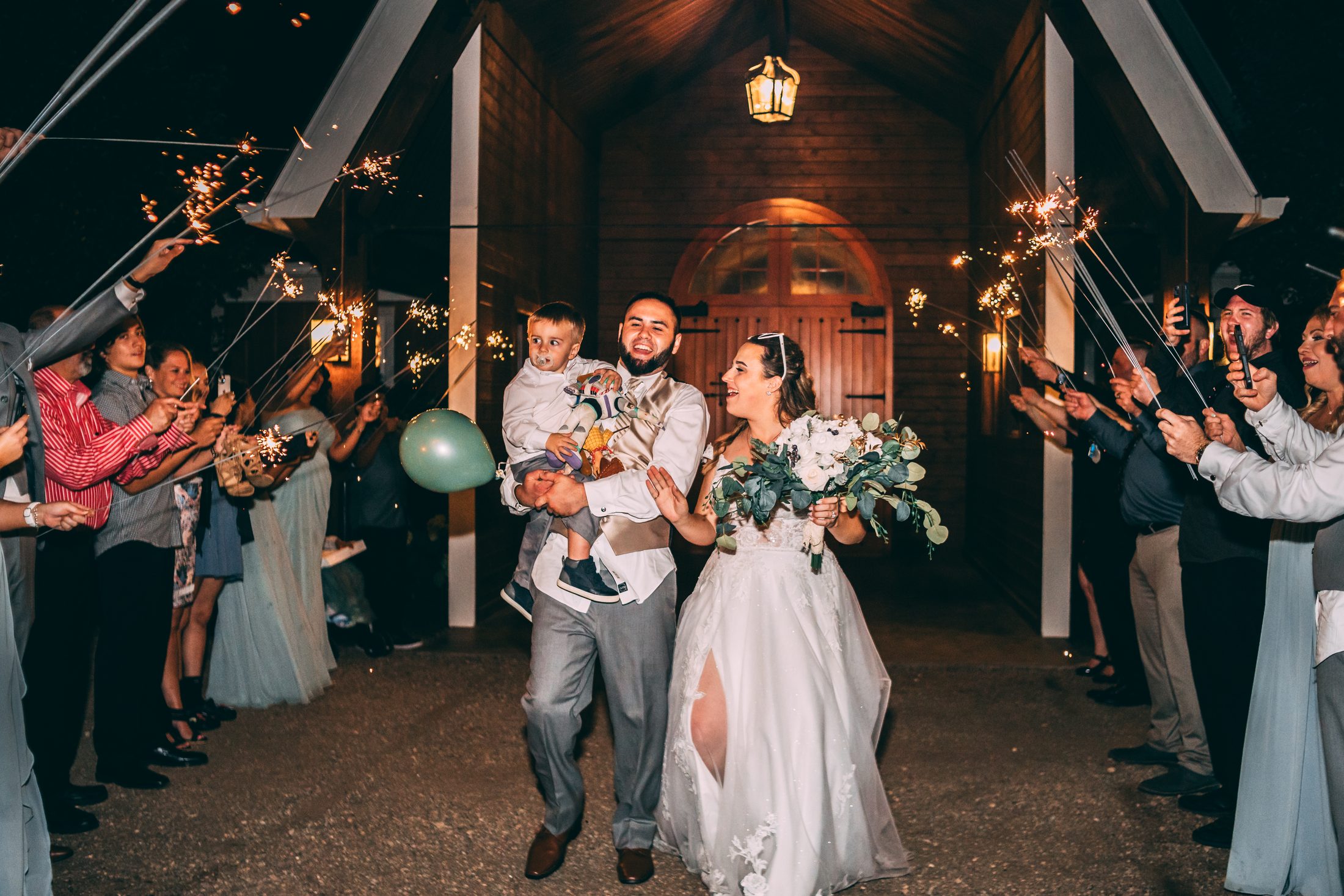 The Weaver bride and groom walking together through a sparkler exit