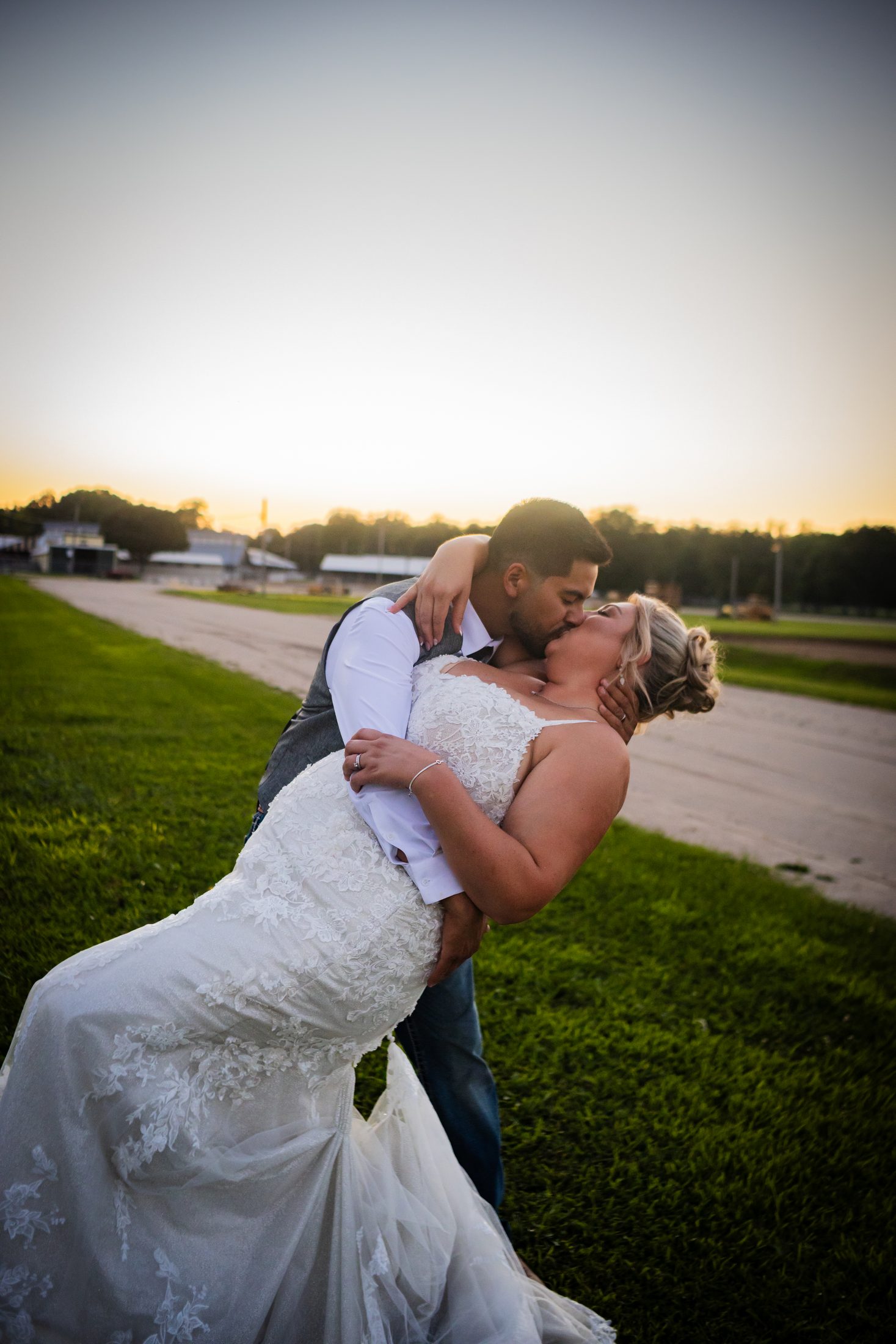 The Pantojas, the groom dipping the bride for a kiss at sunset