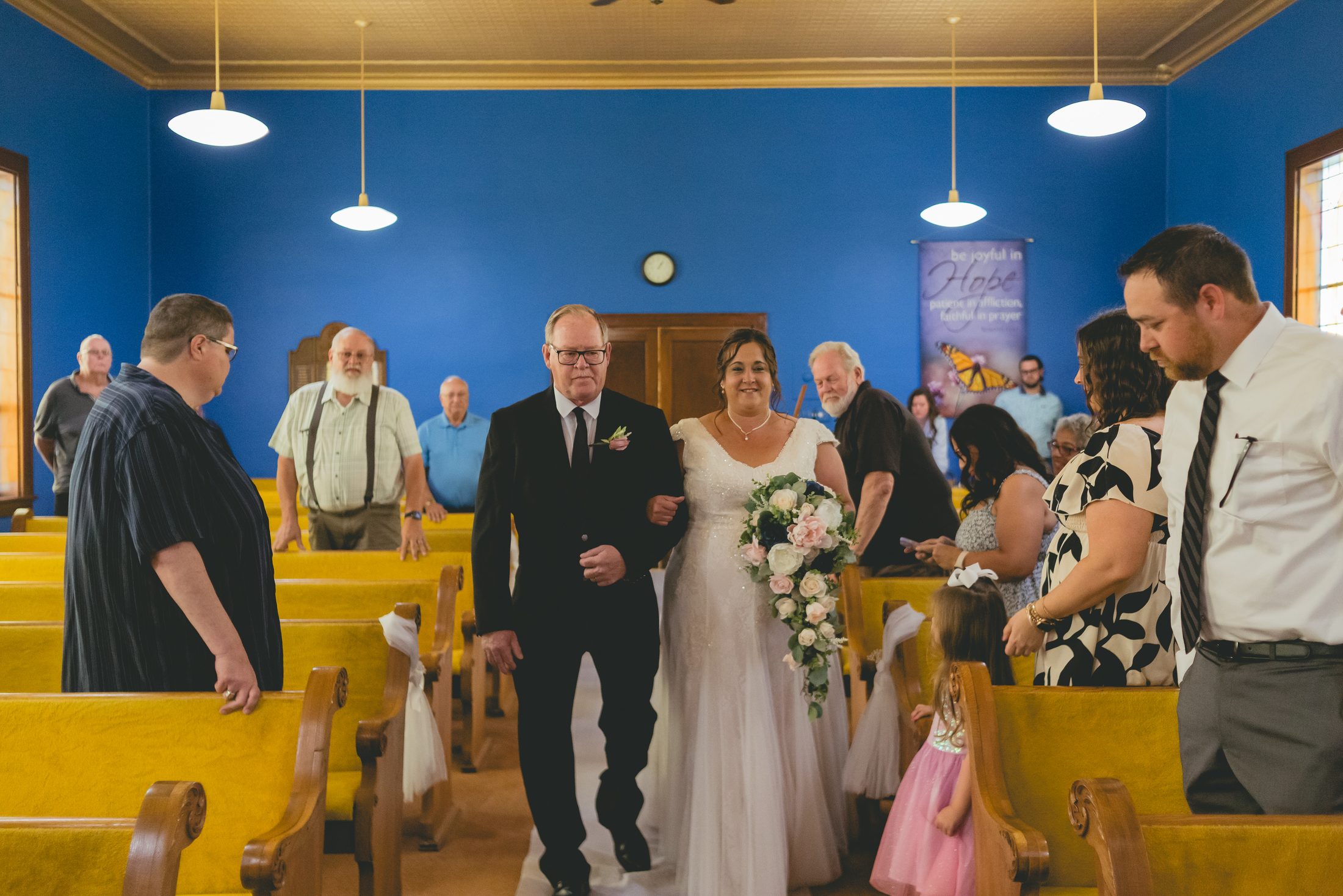 The Davidson bride walking down the church aisle with her father